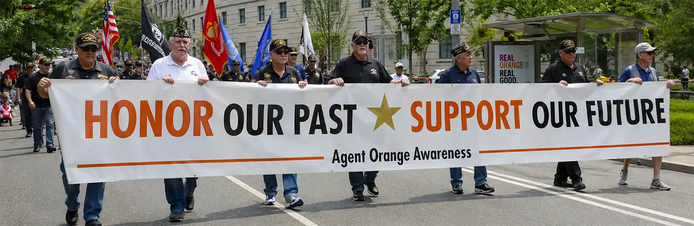 Veterans march for Agent Orange Awareness Veterans march together during an Agent Orange awareness event, carrying a large banner calling for remembrance, support, and recognition of those affected by Agent Orange exposure during the Vietnam War.