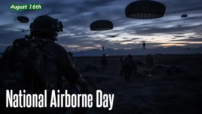 U.S. airborne soldiers land by parachute on a dark pre-dawn drop zone as fellow paratroopers move into position beneath the fading night sky.