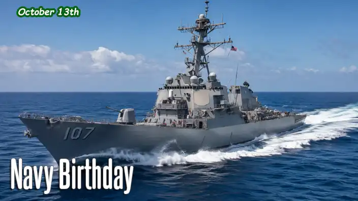 A modern U.S. Navy destroyer speeds across calm blue seas, throwing up white spray as it powers forward beneath a bright sky with the American flag flying proudly.
