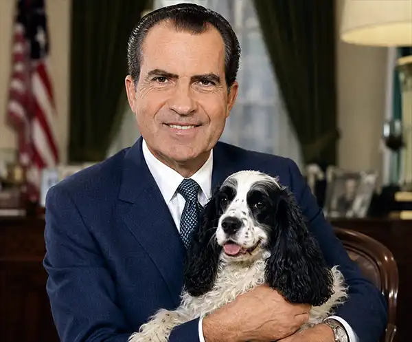 A portrait-style image of Richard Nixon seated in a presidential office, holding Checkers, the black-and-white cocker spaniel made famous by the 1952 Checkers Speech. The dog rests comfortably in Nixon's arms as the American flag and office furnishings create a formal historical setting.